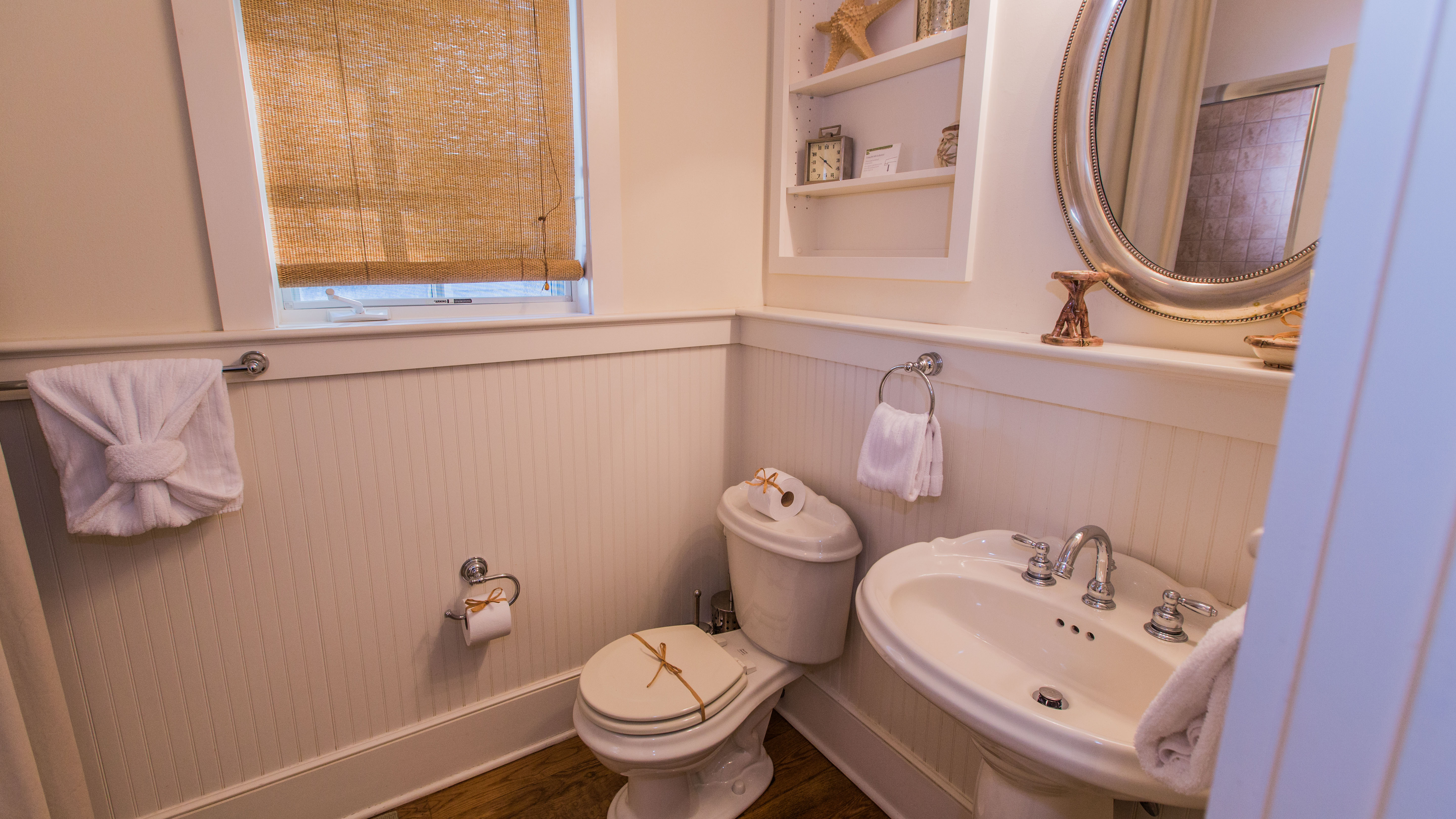 En suite bath features pedestal sink and tub/shower combination